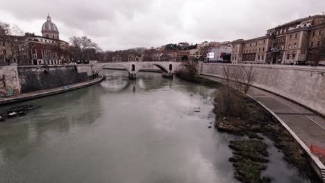 serene views of the tiber river flowing through urban rome during a calm winter afternoon