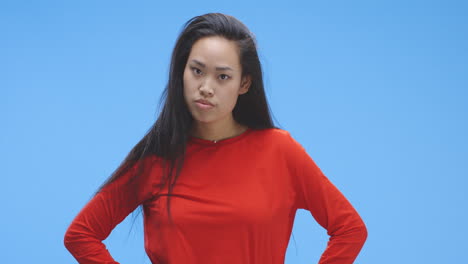 woman in red top, looking displeased