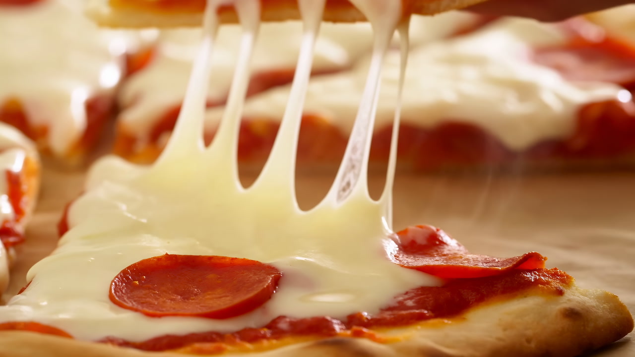 Melting Cheese On Pepperoni Pizza, Gooey Mozzarella Stretching As Slice Is Lifted, Tomato Sauce Peeking