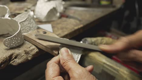 jeweler at work in jewelry. desktop for craft jewelry making with professional tools. close up view of tools.