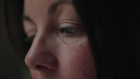an extreme close-up of a woman's eye, revealing intricate facial details as she focuses intently. soft natural lighting enhances the depth and emotion in the moment.