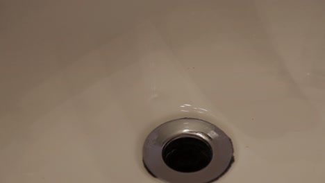 water droplets falling onto a drain