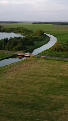 aerial view of canal and bridge in rural landscape