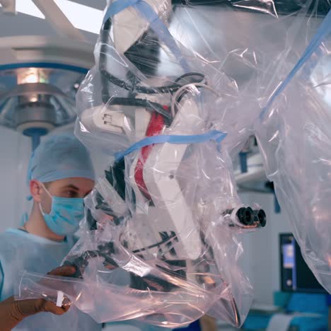 modern equipment in the operating room. surgeon customizes medical microscope in clinic. new technologies in medicine.
