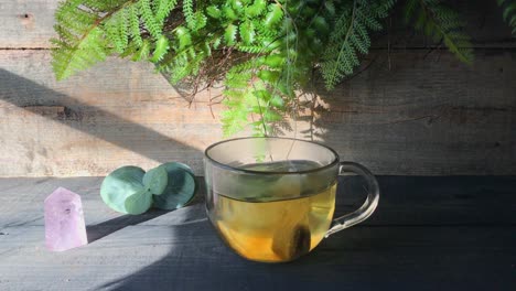 side view making nature inspired clear glass mug of tea with healing vibes