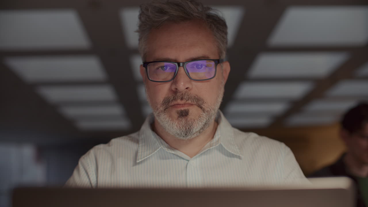 Senior Businessman Working on Laptop Late in Office