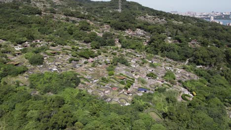 Chinese-cemetery-hill-in-Taipei,-adorned-with-gravestones-and-pathways,-embodies-tradition,-serenity,-and-elegant-architecture-amidst-lush-greenery