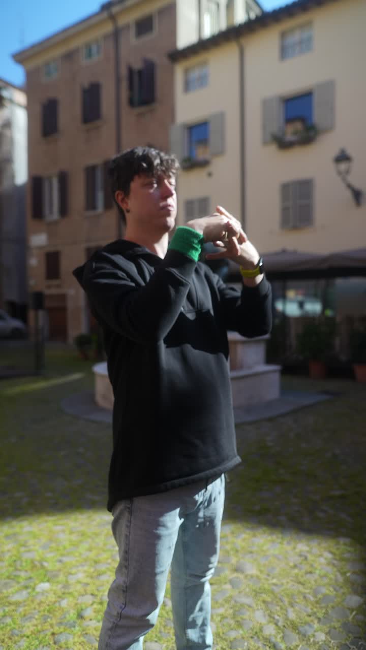 Young man in a city square
