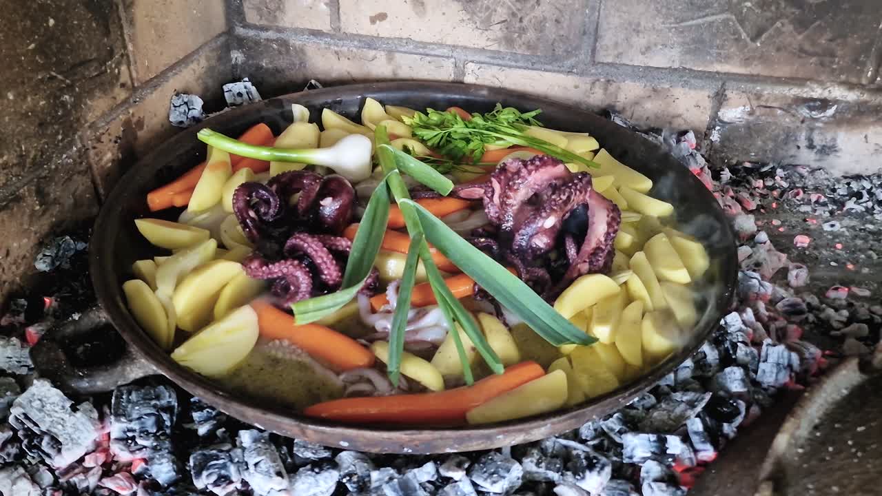 Octopus under the bell is a popular Dalmatian dish made by slowly cooking a fresh octopus with potatoes onions and carrots