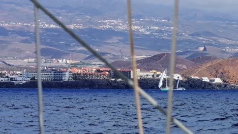 tenerife’s coastal resorts and mountain ridges seen from yacht, atlantic sea