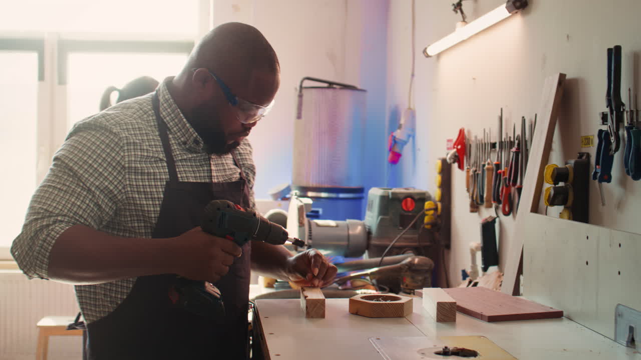 Craftsperson sinks screws into wood block with electric tool