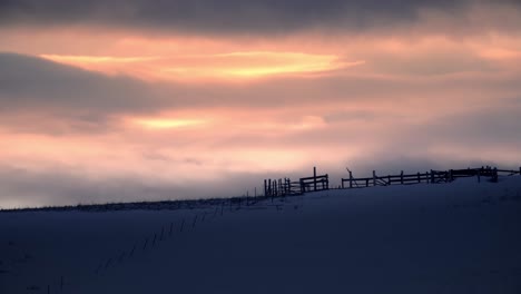 Timelapse-Sunset-Over-Horse-Corrals,-Western-World,-Snowy-Landscape,-4K