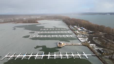 aerial push in on a snow covered dock at presque isle state park.