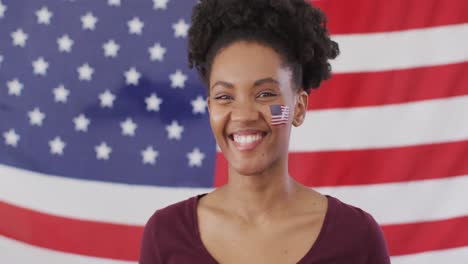 video of excited afrcian american woman with flag of usa watching match in tv