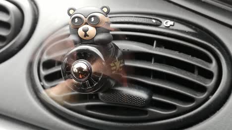 car interior air conditioner teddy bear racing airplane with fast spinning propeller on dashboard vent