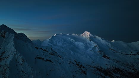 drone footage of a glacier in south tyrol during the blue hour before sunrise, slowly revealing the majestic mountainscape