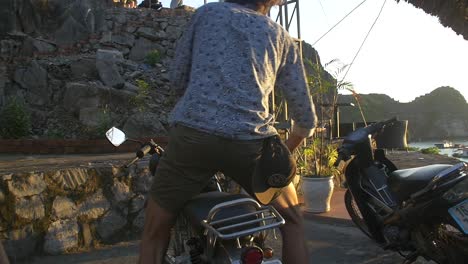 Man-Dismounting-Motorbike-Ha-Long-Bay