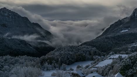 time lapse of some clouds over snowy mountains