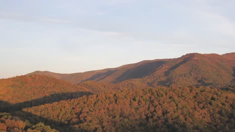 panning shot of russet colored mountains in autumn