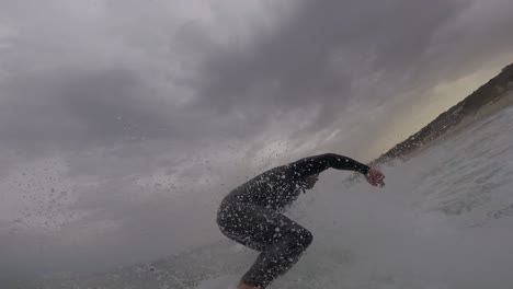 4k view of man surfing in arriba beach surrounded by some clouds