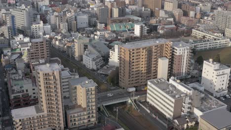 tokyo, aerial rise in early morning in urban environment of japan