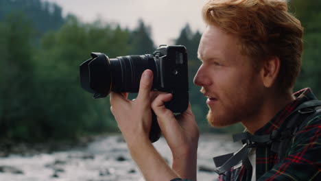 Photographer-using-photo-camera.-Man-taking-photos-during-hike-in-mountains