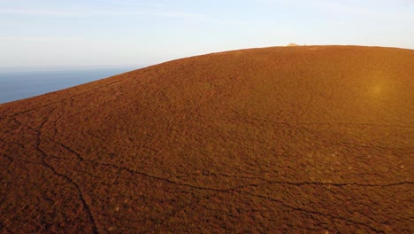 Beautiful-Aerial-Drone-Footage-at-Sunset-Showing-Moor-Peak-with-Ancient-Stone-Cairn-in-Devon-UK-4K