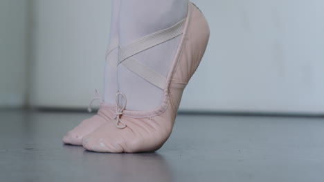 a ballerina does a foot warm-up