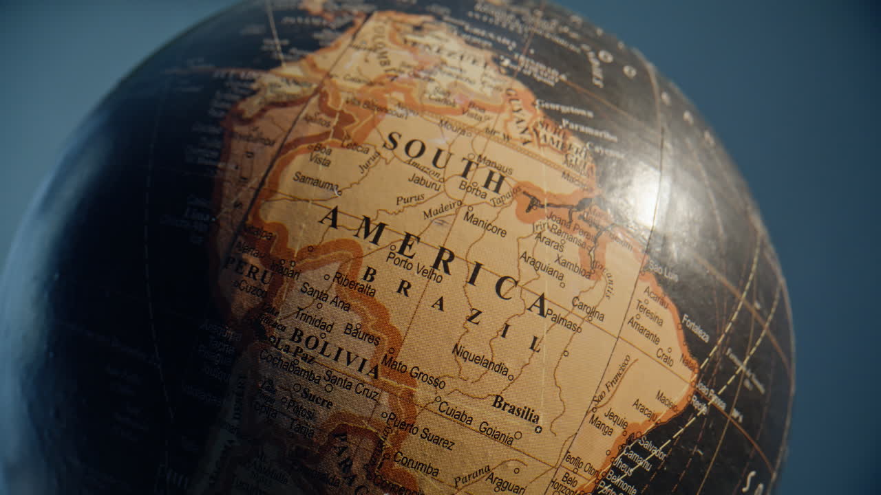 South America marked globe standing in educational environment closeup zoom out