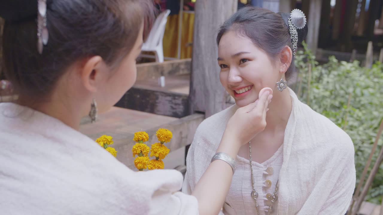 Two Teenage Girls In Thai Traditional Dress Applying Make Up, Slow Motion