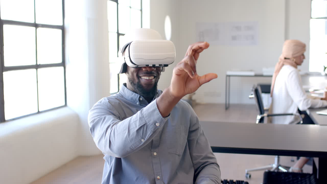 Using VR headset, man interacting with virtual objects in modern office