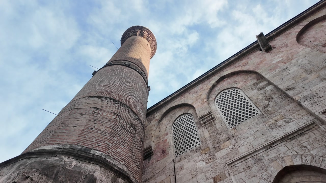 Low Angle View of a Historic Mosque Minaret and Stone Building