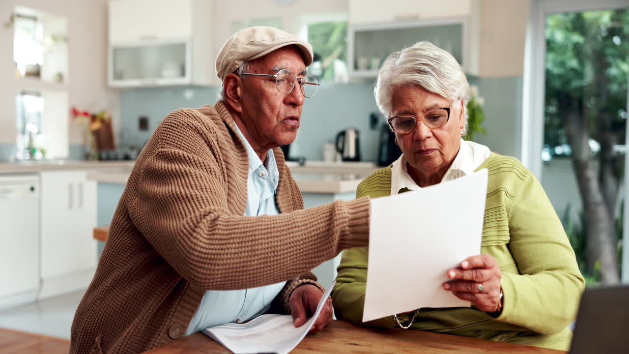 Senior couple reviewing financial documents at home