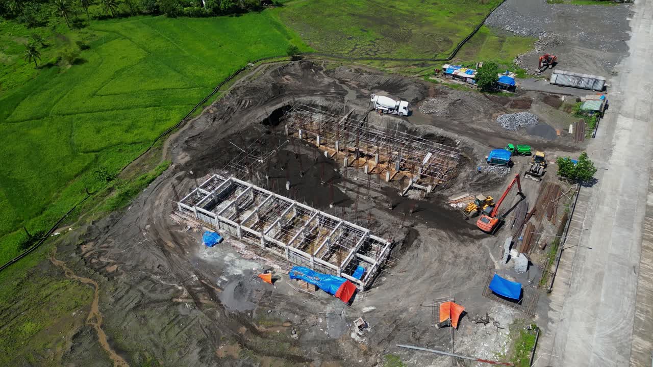 Cement Mixer Truck, Excavator, And Loader At The Construction Site Of Building. - aerial shot