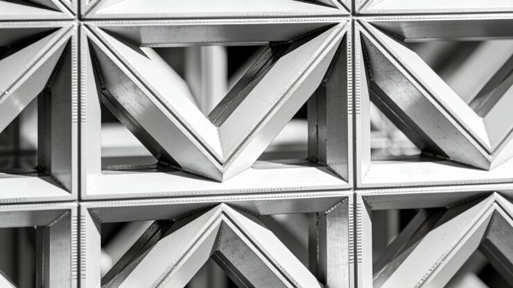 Panning camera revealing repeating metal grid panel in showroom, highlighting V-shaped chevrons