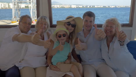 family on board the ship showing thumbs-up