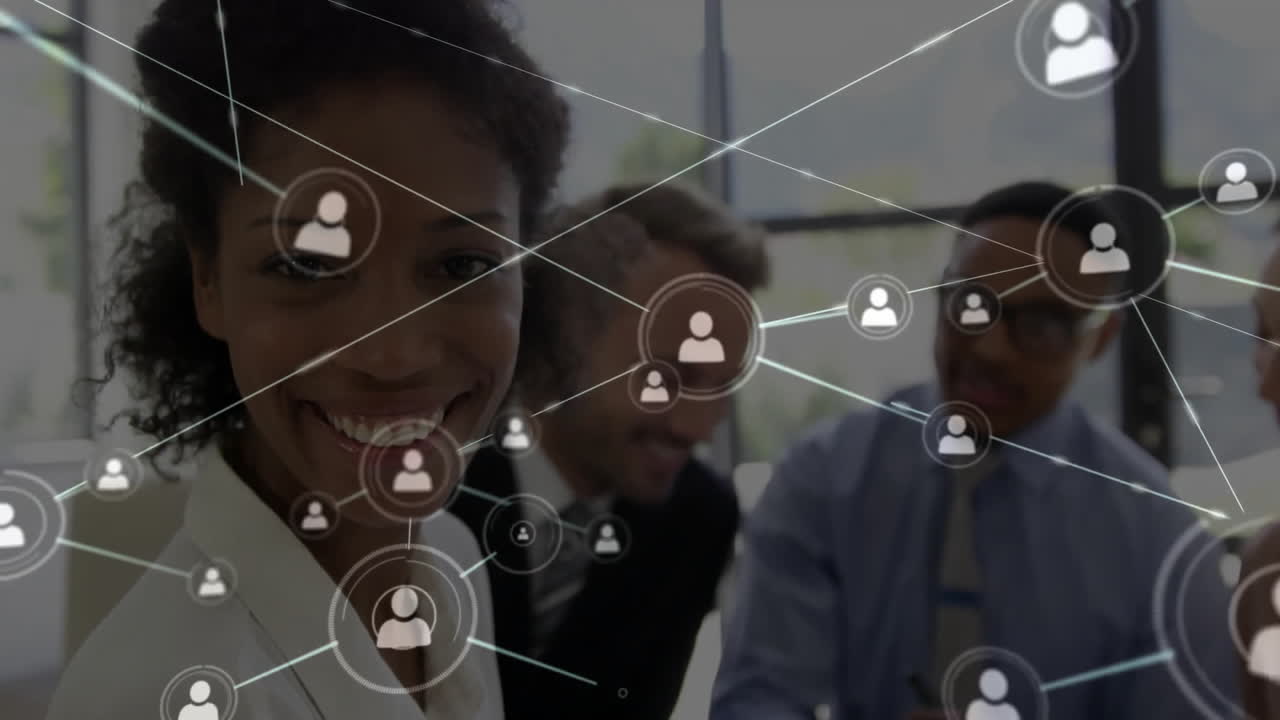 Animation of network of people icons over happy diverse colleagues at office