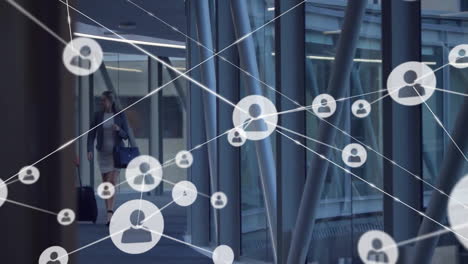 animation of network of connections with icons over caucasian businesswoman in office