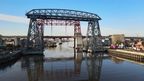 Low-drone-pan---historical-Transporter-Bridge-reflected-in-river