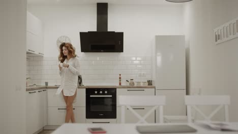 happy woman making morning tea at home. smiling lady opening laptop computer