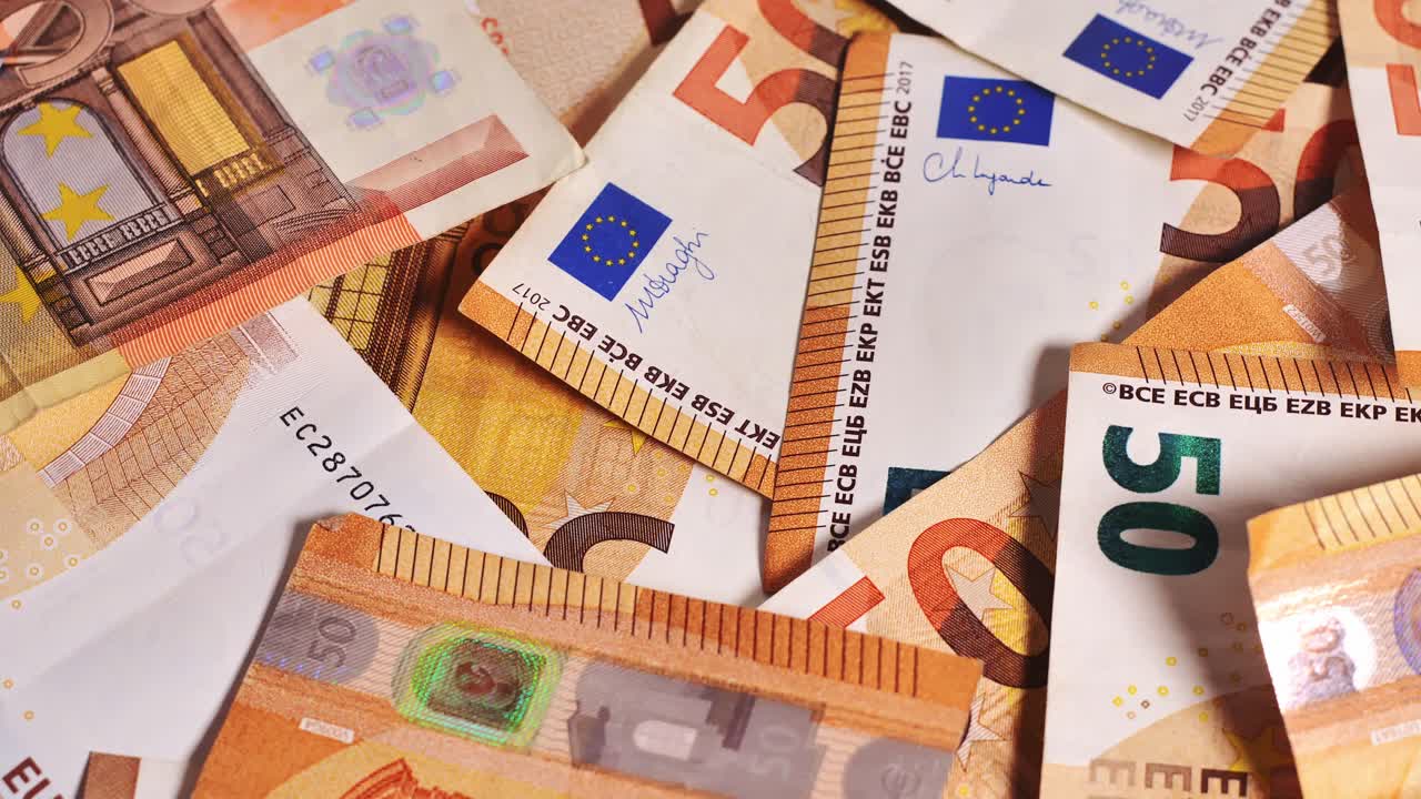 Fast-spinning 50 euro banknotes on platform, symbolizing financial movement