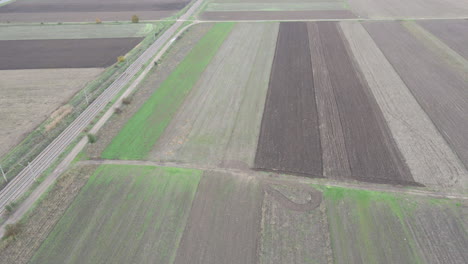 Brown-worn-farmland-drone-aerial-over-road-to-reveal-sky