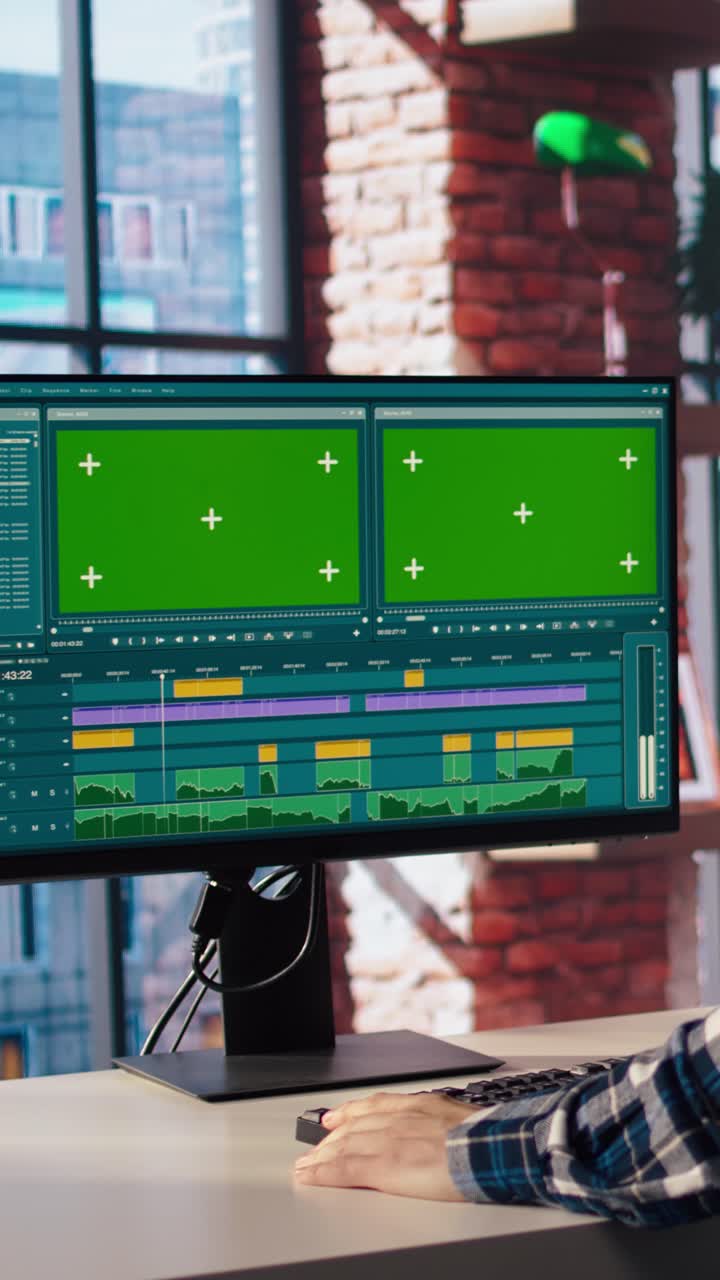 Vertical video Videographer professionally adjusting clips using green screen computer