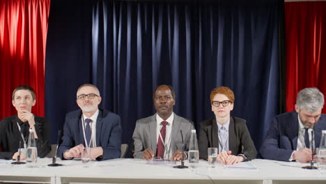 group portrait of multiethnic politicians at press conference