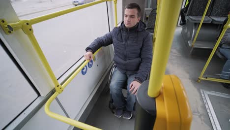 person with a physical disability inside public transport with an accessible ramp