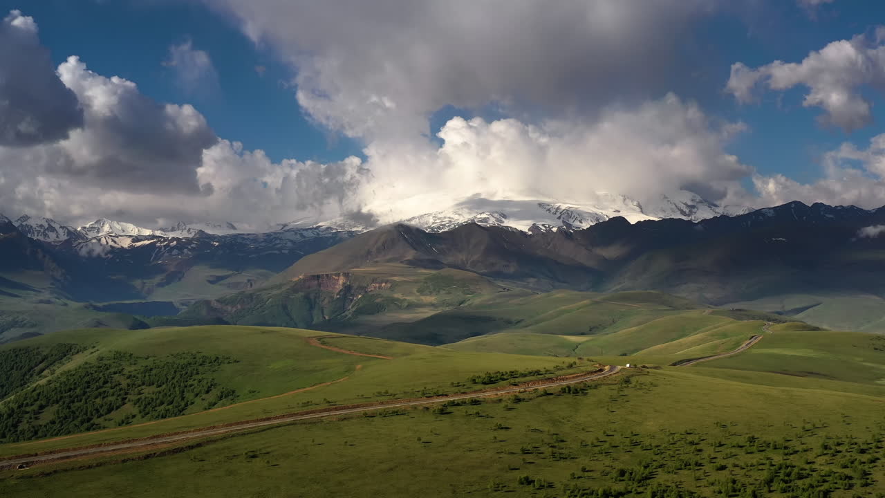 Elbrus Region. Flying over a highland plateau. Beautiful landscape of nature. Mount Elbrus is visible in the background.