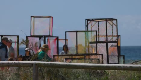 people interacting with colorful cube art installation