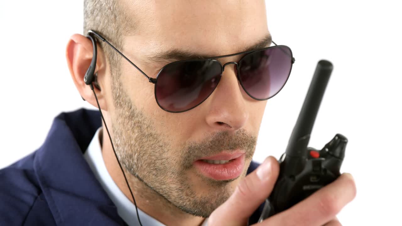 Security guard talking on walkie talkie