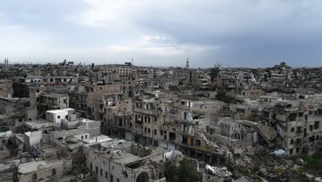 aerial view over houses in aleppo under a cloudy sky. we can see the buildings and houses of the syrian city in ruins after the war 4k