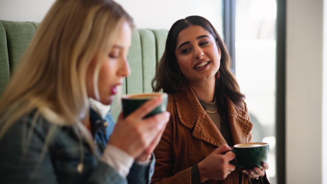 Two women drinking coffee at a cafe